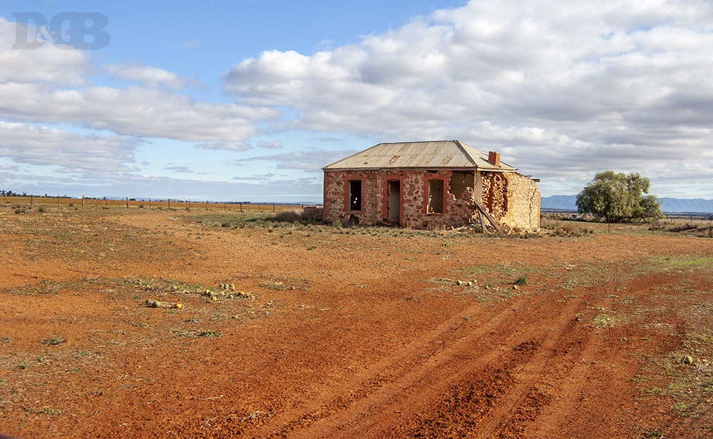 Rustic old stone building on rich red outback soil